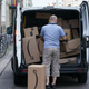 A courier unloads Amazon packages during a delivery on June 18, 2020 in Berlin, Germany.